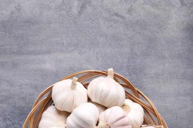 Garlic in basket on grey wooden table